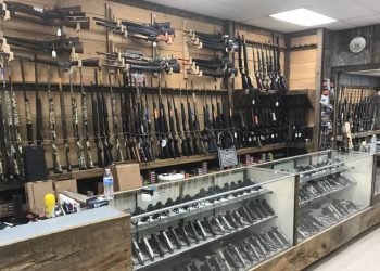 Interior of store with display case and guns 