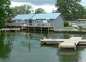 Grey and blue cabins with wooden docks on the water