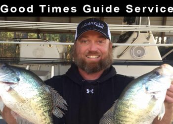 Man in a black shirt and white and black hat holding two crappie