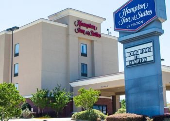 Exterior of Hampton Inn with sign on a bright day