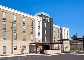 Exterior of Home2Suites on a bright day. 