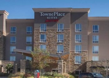 Exterior of Towne Suites during the daytime.